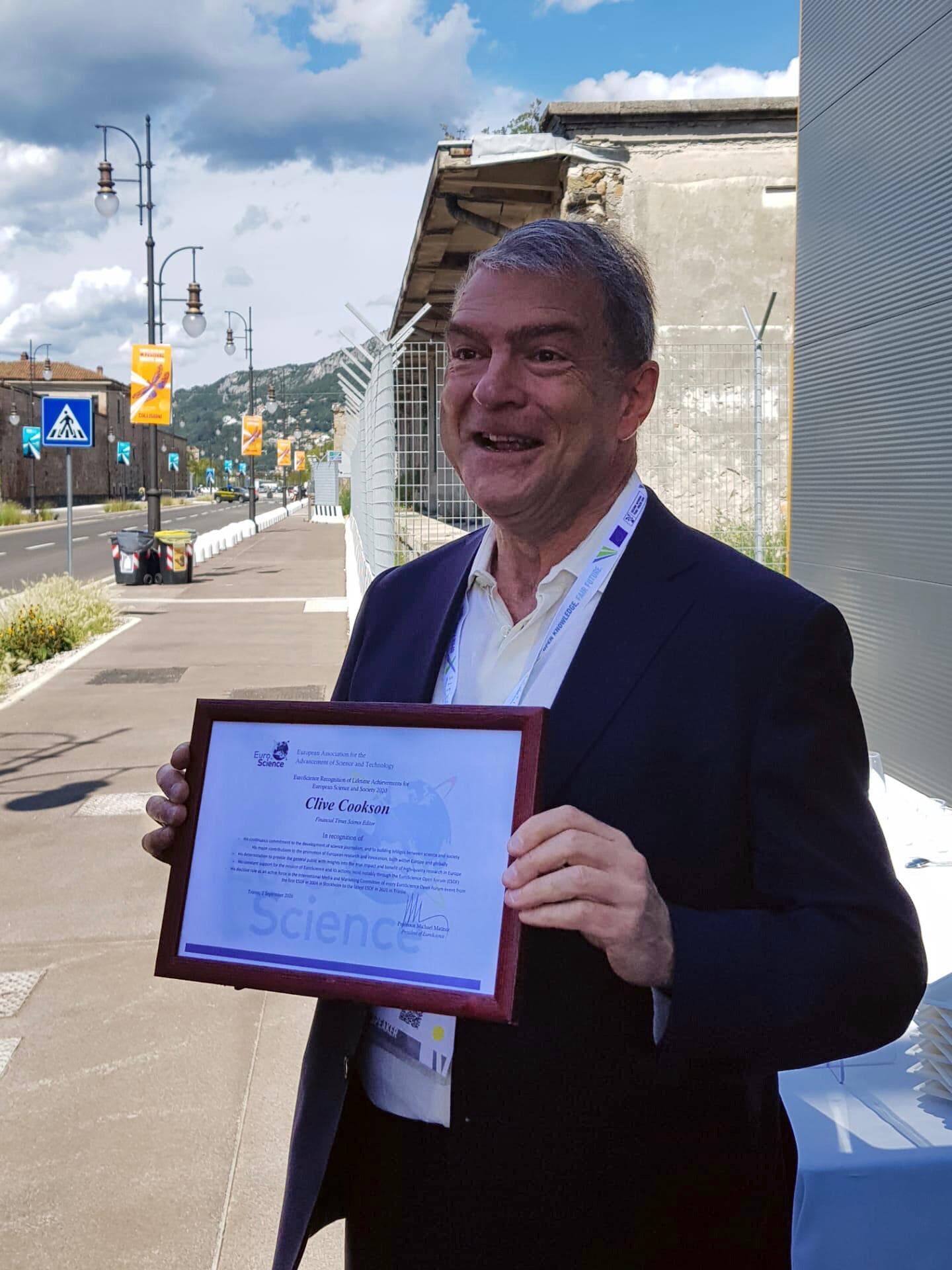 Clive Cooksen proudly shows off his Euroscience's Lifetime Achievement Award